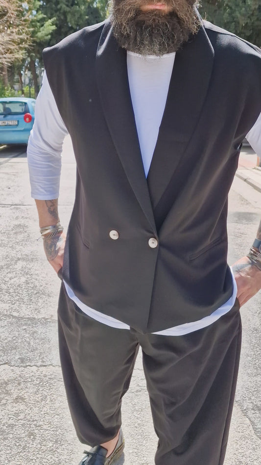Clint wore trousers and a sleeveless jacket.